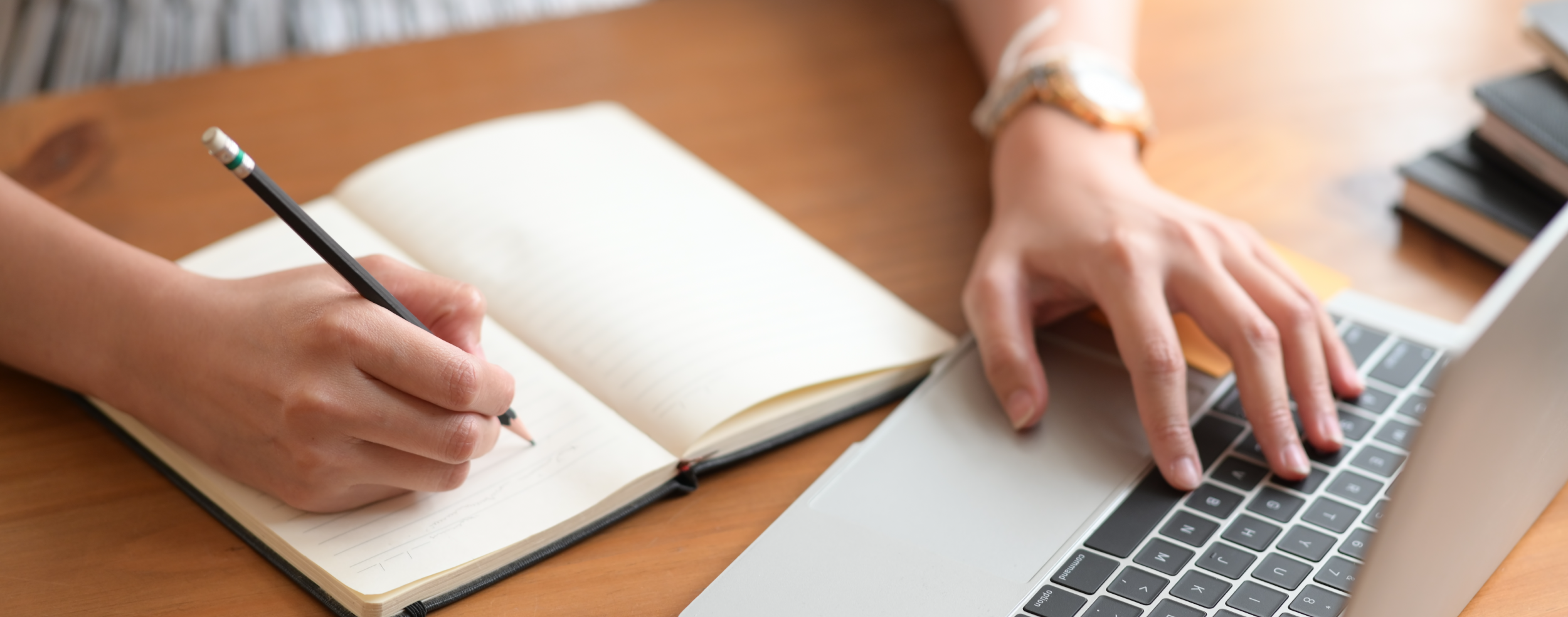 Hand writing and typing on laptop